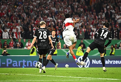 Stuttgart's Tiago Tomas, center, scores the winning goal during a German Cup semifinal soccer match between VfB Stuttgart and SC Freiburg, in Stuttgart, Germany. 
