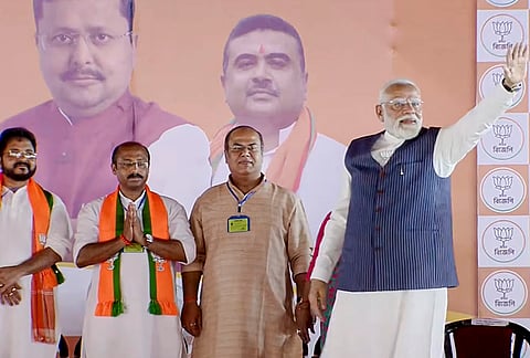 Prime Minister Narendra Modi, right, with party candidates during a campaign for the West Bengal Assembly elections, in Dum Dum, North 24 Parganas district. 