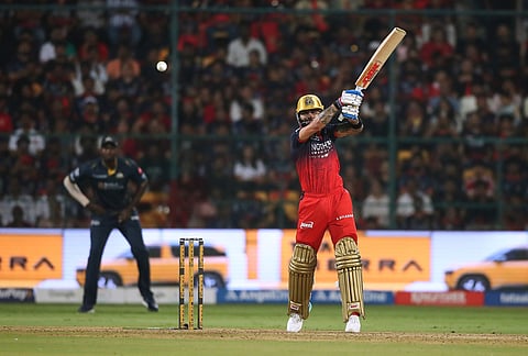 Royal Challengers Bengaluru's Virat Kohli hits a boundary during the Indian Premier League cricket match between Royal Challengers Bengaluru and Gujarat Titans in Bengaluru.