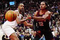 | Photo: Frank Gunn/The Canadian Press via AP : Toronto Raptors' Collin Murray-Boyles (12) passes around Cleveland Cavaliers' Evan Mobley (4) during the second half of an NBA basketball playoff game in Toronto.