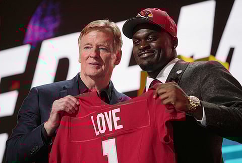 Notre Dame running back Jeremiyah Love, right, poses with NFL Commissioner Roger Goodell after being chosen by the Arizona Cardinals with the third overall pick during the first round of the NFL football draft, in Pittsburgh. 