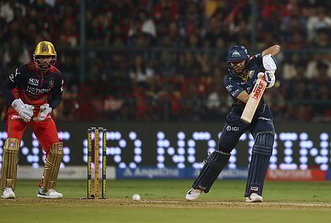Gujarat Titans' captain Shubman Gill plays a shot during the Indian Premier League cricket match between Royal Challengers Bengaluru and Gujarat Titans in Bengaluru.