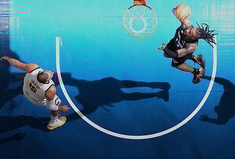 Minnesota Timberwolves guard Ayo Dosunmu (13) shoots as Denver Nuggets center Nikola Jokic (15) defends during the first half in Game 3 of a first-round NBA basketball playoff series, in Minneapolis.