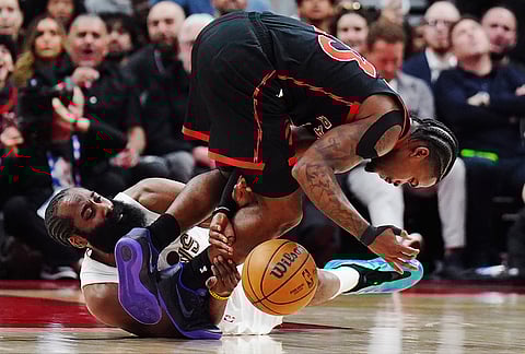 Toronto Raptors' Jamal Shead (top) steals the ball from Cleveland Cavaliers' James Harden (1) during the second half of an NBA playoff basketball game in Toronto.
