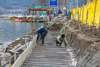 Job Outsourcing In J&K Raises Youth Concerns IMAGO / NurPhoto : Informal economy workers on the banks of Dal Lake in Srinagar, Jammu and Kashmir