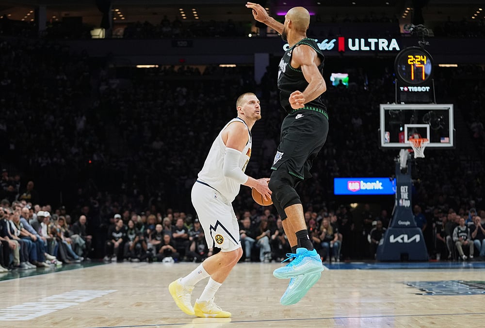 Denver Nuggets center Nikola Jokic (15), back, looks to shoot as Minnesota Timberwolves center Rudy Gobert (27) defends during the first half in Game 3 of a first-round NBA basketball playoff series in Minneapolis.  - | Photo: AP/Abbie Parr