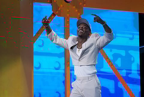 Ohio State wide receiver Carnell Tate celebrates after being chosen by the Tennessee Titans with the fourth overall pick during the first round of the NFL football draft, in Pittsburgh. 