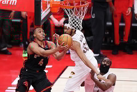 Toronto Raptors' Scottie Barnes (4) shoots as Cleveland Cavaliers' Jarrett Allen (31) and James Harden (1) defend during the second half of an NBA playoff basketball game in Toronto.