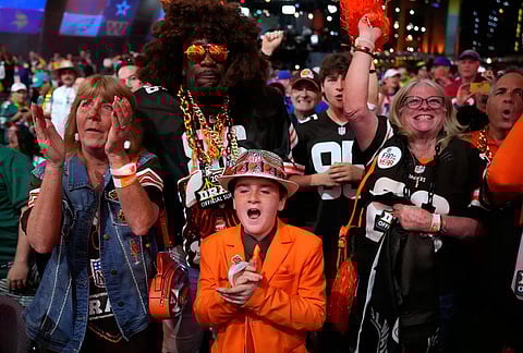 Cleveland Browns fans cheer during the first round of the NFL football draft, in Pittsburgh. 