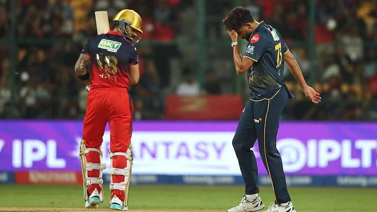 Gujarat Titans' Mohammed Siraj reacts after a catch of Royal Challengers Bengaluru's Virat Kohli, ledt, was dropped during the Indian Premier League cricket match between Royal Challengers Bengaluru and Gujarat Titans in Bengaluru, India, Friday, April 24, 2026. - (AP Photo)