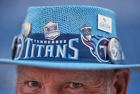 Tennessee Titans fan Tommy Miles wears a hat during an NFL football draft party in Nashville, Tennessee.