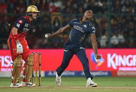 Gujarat Titans' Kagiso Rabada bowls a delivery during the Indian Premier League cricket match between Royal Challengers Bengaluru and Gujarat Titans in Bengaluru.