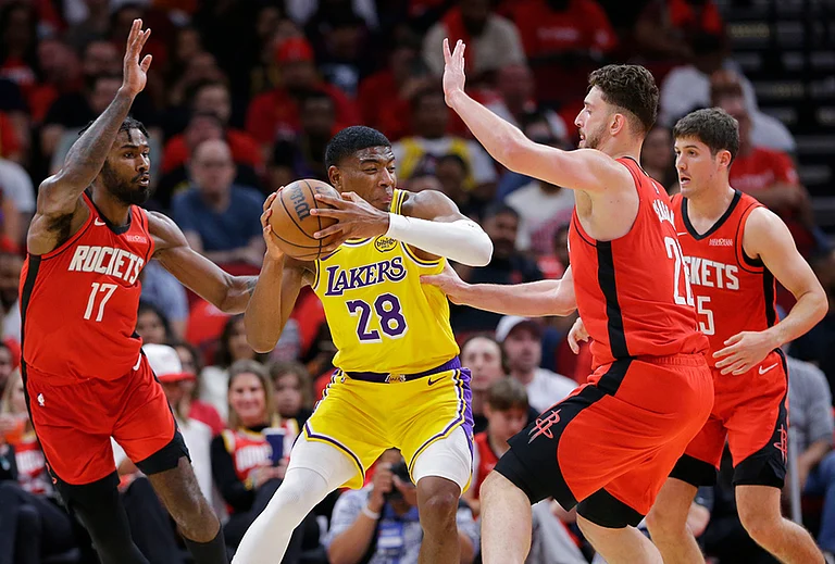 Los Angeles Lakers forward Rui Hachimura (28) is surrounded by Houston Rockets forward Tari Eason (17), center Alperen Sengun (28) and guard Reed Sheppard, right, during the second half of Game 3 in a first-round NBA playoffs basketball series in Houston. - | Photo: AP/Michael Wyke