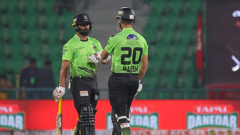 Lahore Qalandars cricketers in action against Peshawar Zalmi in PSL 2026 clash at the Gaddafi Stadium in Lahore. - thepslt20/X