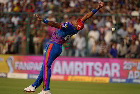 Delhi Capitals' Lungi Ngidi loses his balance while attempting a catch in the field during the Indian Premier League cricket match between Delhi Capitals and Punjab Kings in New Delhi.