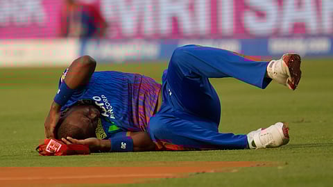 Delhi Capitals' Lungi Ngidi writhes in pain on the ground after attempting to take a catch during the Indian Premier League cricket match between Delhi Capitals and Punjab Kings in New Delhi, India, Saturday, April 25, 2026.
