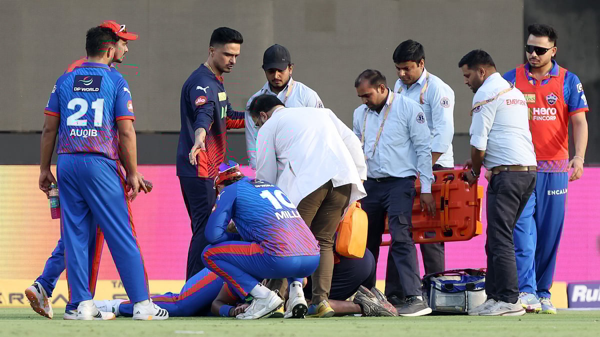 Lungi Ngidi receiving treatment inside the field after suffering head injury during the DC vs PBKS match while taking a catch.  - IPL/X