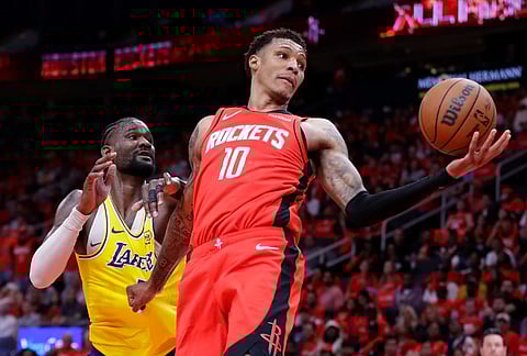 Houston Rockets forward Jabari Smith Jr. (10) pulls in a rebound in front of Los Angeles Lakers center Deandre Ayton, left, during the second half of Game 3 in a first-round NBA playoffs basketball series in Houston.
