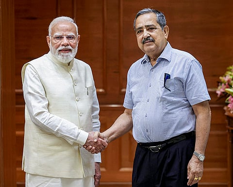 Prime Minister Narendra Modi, left, exchanges a handshake with newly-appointed Vice Chairman of Niti Aayog Ashok Lahiri. 