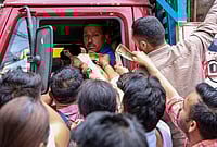 | Photo: PTI : People rush to pay and collect LPG cylinders from a delivery truck carrying cylinders amid the ongoing supply crisis, at the McLeodganj Chowk, in Dharamshala, Himachal Pradesh.