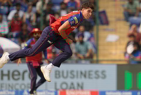 Punjab Kings' Xavier Bartlett bowls a delivery during the Indian Premier League cricket match between Delhi Capitals and Punjab Kings in Delhi.