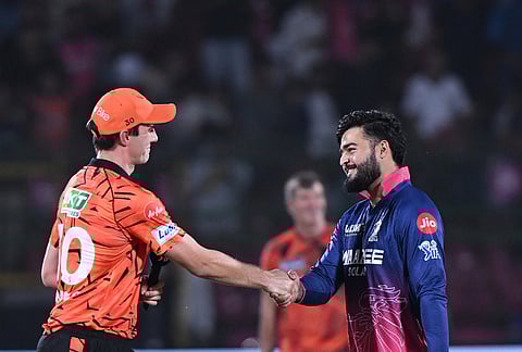 Sunrisers Hyderabad's captain Pat Cummins, left, and Rajasthan Royals' captain Riyan Parag shake hands after coin toss before the Indian Premier League cricket match between Rajasthan Royals and Sunrisers Hyderabad in Jaipur.