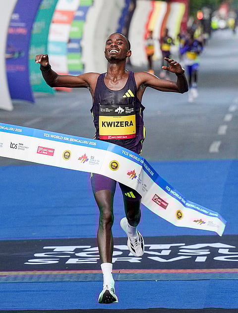 Burundian long-distance runner Rodrigue Kwizera celebrates after crossing the finish line during the TCS World 10K marathon, in Bengaluru.