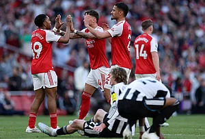| Photo: AP/Ian Walton : Arsenal players celebrate at the end the English Premier League soccer match between Arsenal and Newcastle United in London.