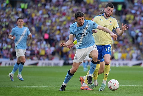 Manchester City's Mateo Kovacic in action in front of Southampton's Finn Azaz during the FA Cup semifinal soccer match between Manchester City and Southampton in Manchester, England.