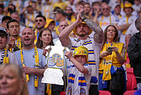Chelsea Vs Leeds United, FA Cup 2025-26 Semi-Final Live: Best Photos From Wembley Stadium | Photo: AP/Kin Cheung : A Leeds fan holds a cutout of FA Cup trophy before the FA Cup semifinal soccer match between Chelsea and Leeds in London, England.