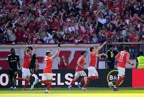 Mainz players celebrate after a goal during a Bundeliga soccer match between Mainz and Bayern in Mainz, Germany.