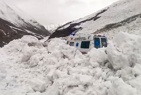 An ambulance remains stuck in snow after an avalanche hit the Srinagar-Leh national highway at Shaitan Nallah, in Jammu and Kashmir.