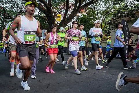 People take part in the TCS World 10K marathon, in Bengaluru.