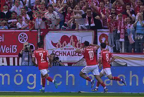 Mainz players celebrate after a goal during a Bundeliga soccer match between Mainz and Bayern in Mainz, Germany.