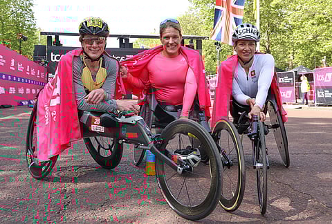 Winner Switzerland's Catherine Debrunner, cneter, second placed Tatyana McFadden of the US, left, and third placed Switzerland's Manuela Schar celebrate after the women's wheelchair race at the London Marathon in London.