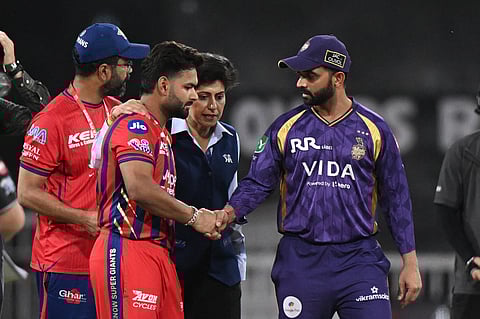 Lucknow Super Giants' captain Rishabh Pant, left, shake hands with Kolkata Knight Riders' captain Ajinkya Rahane before the toss of the Indian Premier League cricket match between Kolkata Knight Riders and Lucknow Super Giants in Lucknow.