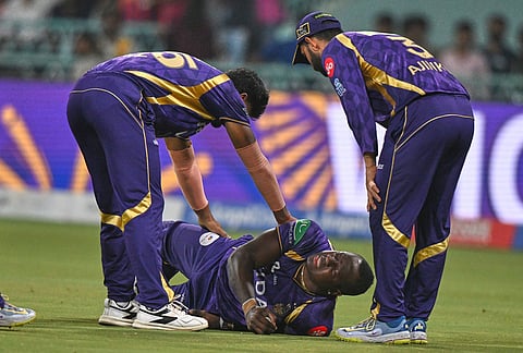 Kolkata Knight Riders' Rovman Powell lay on the ground in pain after getting injured while taking a catch to dismiss Lucknow Super Giants' Mitchell Marsh during the Indian Premier League cricket match between Kolkata Knight Riders and Lucknow Super Giants in Lucknow.