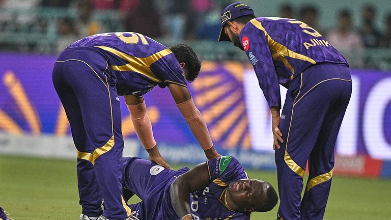 Rovman Powell lay on the ground in pain after getting injured while taking a catch to dismiss Mitchell Marsh during the Indian Premier League match between Kolkata Knight Riders and Lucknow Super Giants in Lucknow. - AP