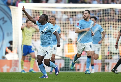 Manchester City's Jeremy Doku celebrates after scoring during the FA Cup semifinal soccer match between Manchester City and Southampton in Manchester, England.