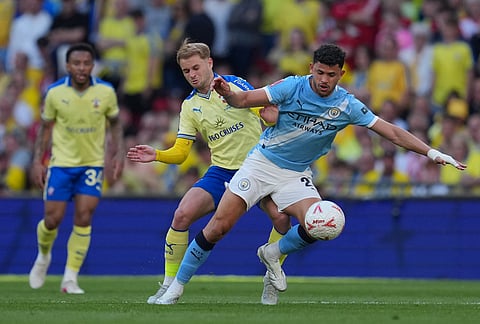 Southampton's Leo Scienza, left, and Manchester City's Matheus Nunes fight for the ball during the FA Cup semifinal soccer match between Manchester City and Southampton in Manchester, England.