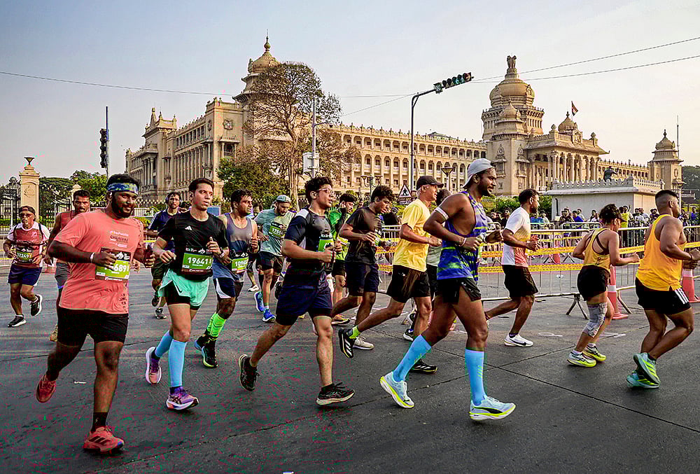 People take part in the TCS World 10K marathon, in Bengaluru. - | Photo: PTI