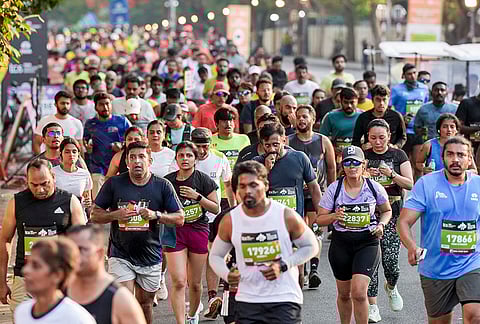 People take part in the TCS World 10K marathon, in Bengaluru.