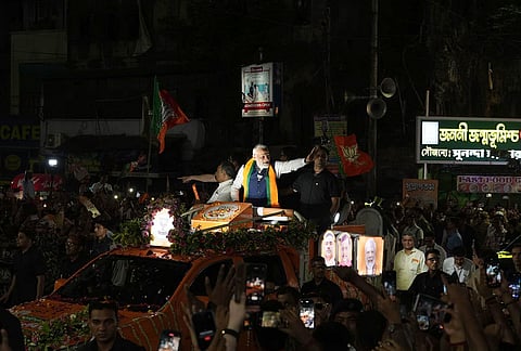 Prime Minister Narendra Modi greets supporters during a roadshow, amid the ongoing West Bengal Assembly elections, in Kolkata.
