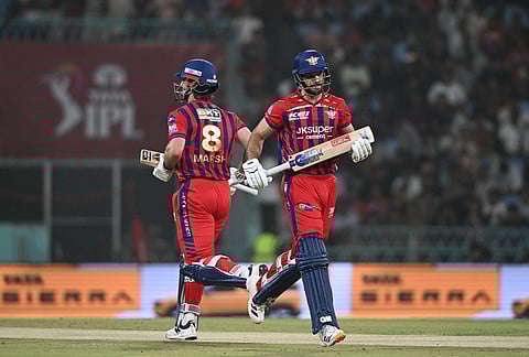Lucknow Super Giants' Aiden Markram, right, and and his batting partner Mitchell Marsh run between the wickets during the Indian Premier League cricket match between Kolkata Knight Riders and Lucknow Super Giants in Lucknow.