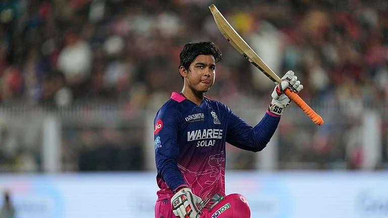 Rajasthan Royals' Vaibhav Sooryavanshi waves his bat as he leaves the ground after losing his wicket during the Indian Premier League cricket match between Royal Challengers Bengaluru and Rajasthan Royals in Guwahati, India. - | Photo: AP/Anupam Nath