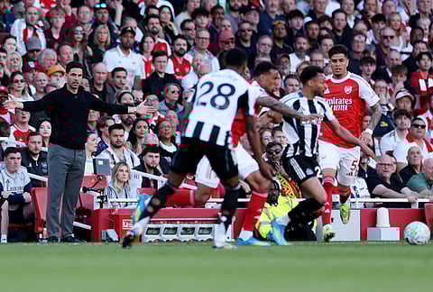Arsenal's manager Mikel Arteta, left, reacts during the English Premier League soccer match between Arsenal and Newcastle United in London.