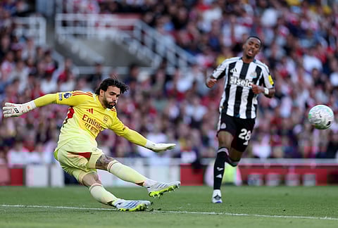 Arsenal's goalkeeper David Raya kicks the ball during the English Premier League soccer match between Arsenal and Newcastle United in London.