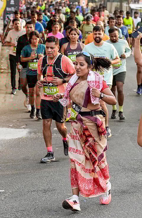 People take part in the TCS World 10K marathon, in Bengaluru.