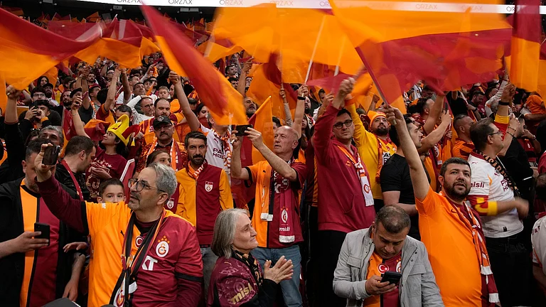 Galatasaray supporter cheer prior a Turkish Super Lig soccer match between Galatasaray and Fenerbahce in Istanbul, Turkey. - AP Photo