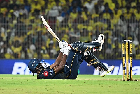 Gujarat Titans' Sai Sudharsan loses his balance after hitting a six during the Indian Premier League cricket match between Chennai Super Kings and Gujarat Titans in Chennai.